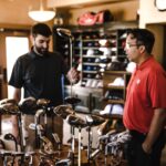 Man Standing Beside Man Holding Gray Golf Club