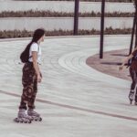 two women inside park while on inline skates