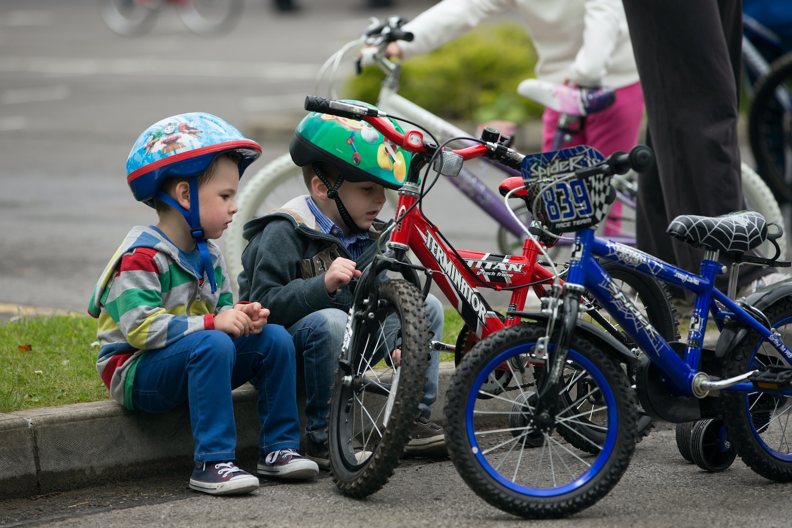 children riding on red mountain bike during daytime