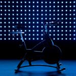 a stationary exercise bike in front of a blue background